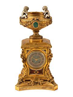 A French Gilt Bronze and Specimen Marble Clock
Height 19 x width 9 1/2 x depth 6 inches.