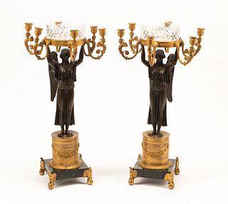 A Pair of Empire Style Gilt and Patinated Bronze Figural Candelabra with Cut Glass Cache Pots
Height 28 1/2 x width of arms 14 inches.