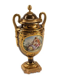 A Gilt Bronze Mounted Sevres Style Porcelain Urn and Cover
Height 17 x width 8 1/2 inches.
