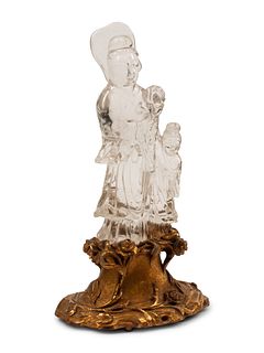 A Carved Rock Crystal Figure of Guanyin on a Giltwood Base
Height overall 12 1/2 inches.