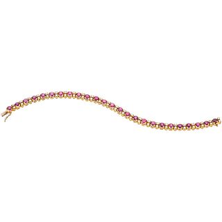BRACELET WITH RUBIES AND DIAMONDS IN 18K YELLOW GOLD with 25 round cut rubies ~7.50 ct and 50 brilliant cut diamonds ~1.25 ct
