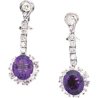 PAIR OF EARRINGS WITH AMETHYSTS IN PALLADIUM SILVER with 2 oval cut amethysts ~7.80 ct and 34 brilliant cut diamonds ~3.80 ct Weight: 11.9 g