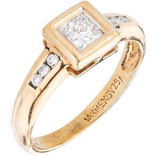 RING WITH DIAMONDS IN 14K YELLOW GOLD 1 princess cut diamond ~0.30 ct and 6 brilliant cut diamonds ~0.07 ct. Size: 5 ¾