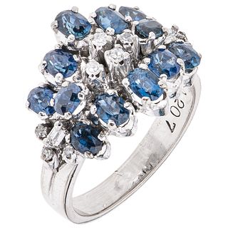RING WITH SAPPHIRES AND DIAMONDS IN PALLADIUM SILVER with 11 oval cut sapphires ~1.10 ct, one blue simulant and 12 diamonds, different cuts