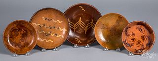 Five redware plates and shallow dishes, 19th c.