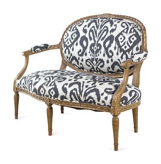 A Louis XVI Style Brunschwig & Fils Upholstered Giltwood Oval Back Settee