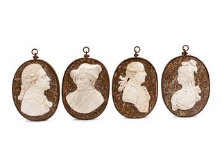 A Set of Four Iron-Framed Carved Marble Portrait Plaques of English Figures 