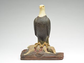 Well carved eagle on wooden base with a carved rabbit in its talons.