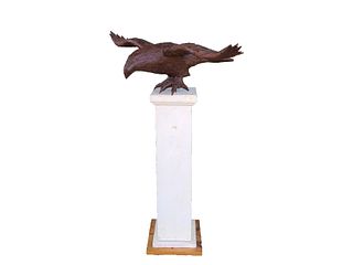 Unique flying spread wing eagle on decorative base.