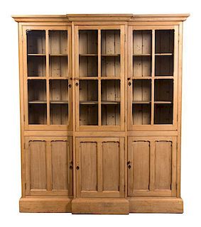 A Georgian Style Pine Breakfront Bookcase Height 85 x width 69 1/2 x depth 13 1/4 inches.