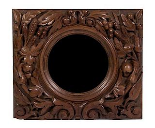 A Victorian Carved Walnut Bullseye Mirror Height 21 x width 24 x depth 3 inches.