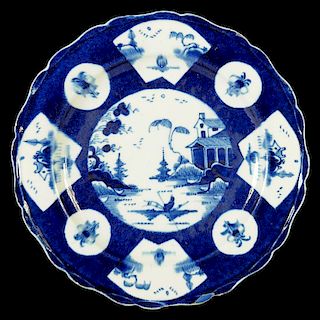 A BOW POWDER BLUE GROUND PLATE, C1758-62 painted with round and fan shaped panels of Chinese