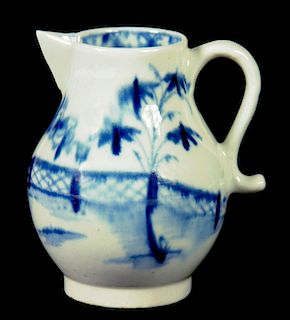 A LOWESTOFT SPARROW BEAK JUG, C1780 painted in underglaze blue with bamboo, peony and a fence, 7.5cm