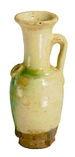 A CHINESE EARTHENWARE WATER DROPPER, TANG DYNASTY  covered in a cream glaze splashed in green and