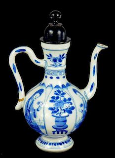 A CHINESE BLUE AND WHITE LAPPET MOULDED EWER, KANGXI painted with alternate panels of figures and