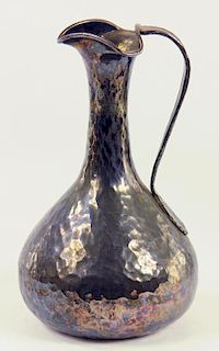 AN ARTS & CRAFTS SILVER HAMMER TEXTURED EWER, THE SLENDER NECK WITH TRIPLE LIP, MARKED 925, EARLY