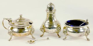 A GEORGE V SILVER THREE PIECE CONDIMENT SET, ON LION MASK FEET, BLUE GLASS LINERS, LONDON 1931, 6OZS