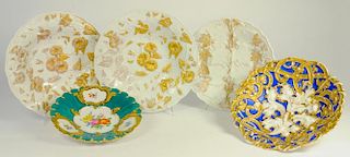 FIVE MEISSEN DISHES, MOULDED IN RELIEF WITH LEAF OR STRAPWORK DESIGNS AND RICHLY GILT, ONE PAINTED