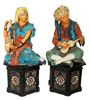 A PAIR OF AUSTRIAN COLD PAINTED TERRACOTTA ORIENTALIST FIGURES OF MUSICIANS SEATED ON HEXAGONAL