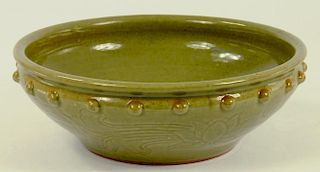 A SONG STYLE CARVED CELADON BOWL WITH STUDDED RIM