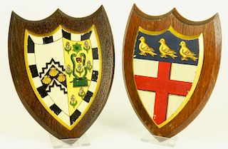 A PAIR OF PAINTED AND GILT OAK SHIELDS OF ARMS OF CAMBRIDGE COLLEGES, PRINTED TRADE LABEL OR A.W.
