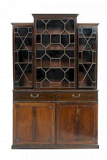 A VICTORIAN MAHOGANY BOOKCASE, LATE 19TH CENTURY the breakfront upper section fitted with adjustable