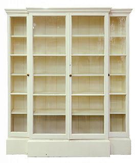 A GEORGE III STYLE WHITE PAINTED BREAKFRONT BOOKCASE ENCLOSED BY FOUR GLAZED DOORS