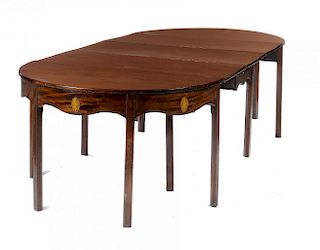 A GEORGE III MAHOGANY DINING TABLE  with drop leaf centre section, the undulating frieze inlaid to