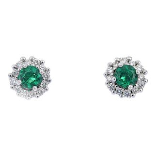 A pair of 18ct gold emerald and diamond cluster ear studs. Each designed as a circular-shape emerald