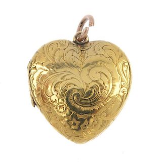 An early 20th century gold heart locket. The scroll engraved front panel, opening to reveal a photog