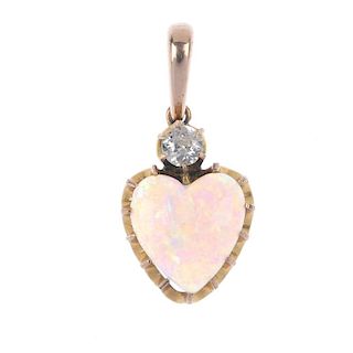 A mid 20th century opal and diamond pendant. The old-cut diamond, set atop a heart-shape opal caboch
