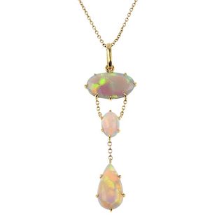 An opal pendant. The pear-shape opal cabochon, suspended from a belcher-link chain, to the oval opal