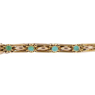 An early 20th century 15ct gold turquoise bracelet. Comprising a series of circular turquoise caboch