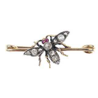 A diamond and ruby insect brooch. The old and rose-cut diamond body and wings, with ruby cabochon ey