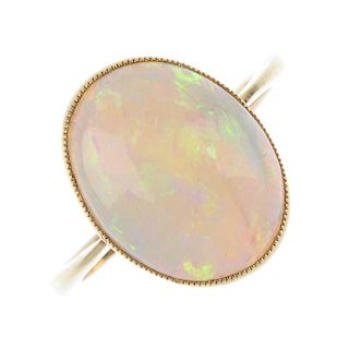 An opal single-stone ring. The oval opal cabochon, with pierced lattice gallery, to the tapered band