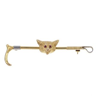 A mid 20th century 9ct gold ruby hunting brooch. The textured fox head, with ruby eye accents, to th