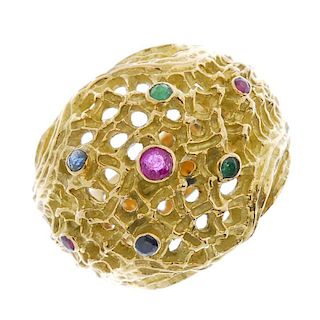 A sapphire, emerald and ruby ring. Designed as a textured openwork dome, with circular-shape emerald
