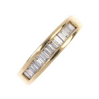 An 18ct gold diamond half-circle eternity ring. The baguette-cut diamond line, inset to the tapered
