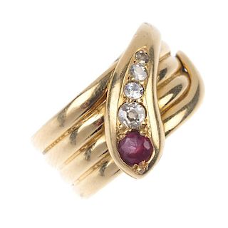 <p>An early 20th century 18ct gold garnet and diamond snake ring. Designed as a coiled serpent, the