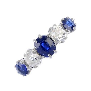 An early 20th century platinum and gold, sapphire and diamond ring. The alternating graduated oval-s