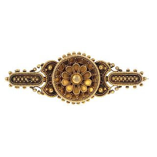 A late 19th century gold brooch. The floral centre, within a cannetille surround, to the similarly-d