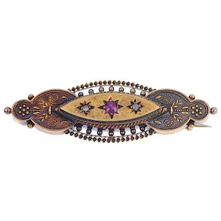 An early 20th century 15ct gold ruby and diamond brooch. The circular-shape ruby and rose-cut diamon