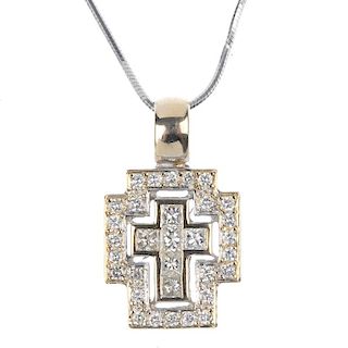 A diamond cross pendant. The square-shape diamond cross, within a brilliant-cut diamond surround, su
