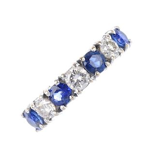 An 18ct gold sapphire and diamond band ring. The alternating brilliant-cut diamond and circular-shap