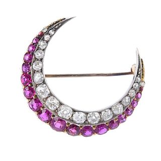 A ruby and diamond crescent brooch. Designed as a series of graduated vari-shape rubies, with a grad