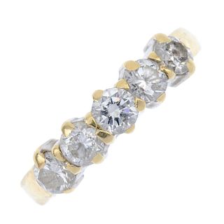 An 18ct gold diamond five-stone ring. The brilliant-cut diamond line, to the tapered band. Total dia