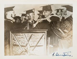 [EINSTEIN] A SIGNED PHOTOGRAPH OF EINSTEIN RECEIVING AN HONORARY DIPLOMA FROM YESHIVA UNIVERSITY, NEW YORK CITY, 1934