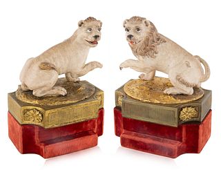 A PAIR OF CERAMIC AND BRASS LION BOOKENDS, EARLY 20TH CENTURY  