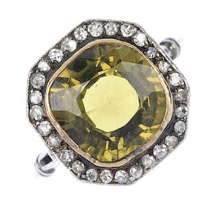 A mid 20th century chrysoberyl and diamond cluster ring. The cushion-shape yellowish green chrysober