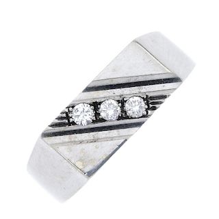 A gentleman's 9ct gold diamond dress ring. The brilliant-cut diamond slanted line with ridged sides,